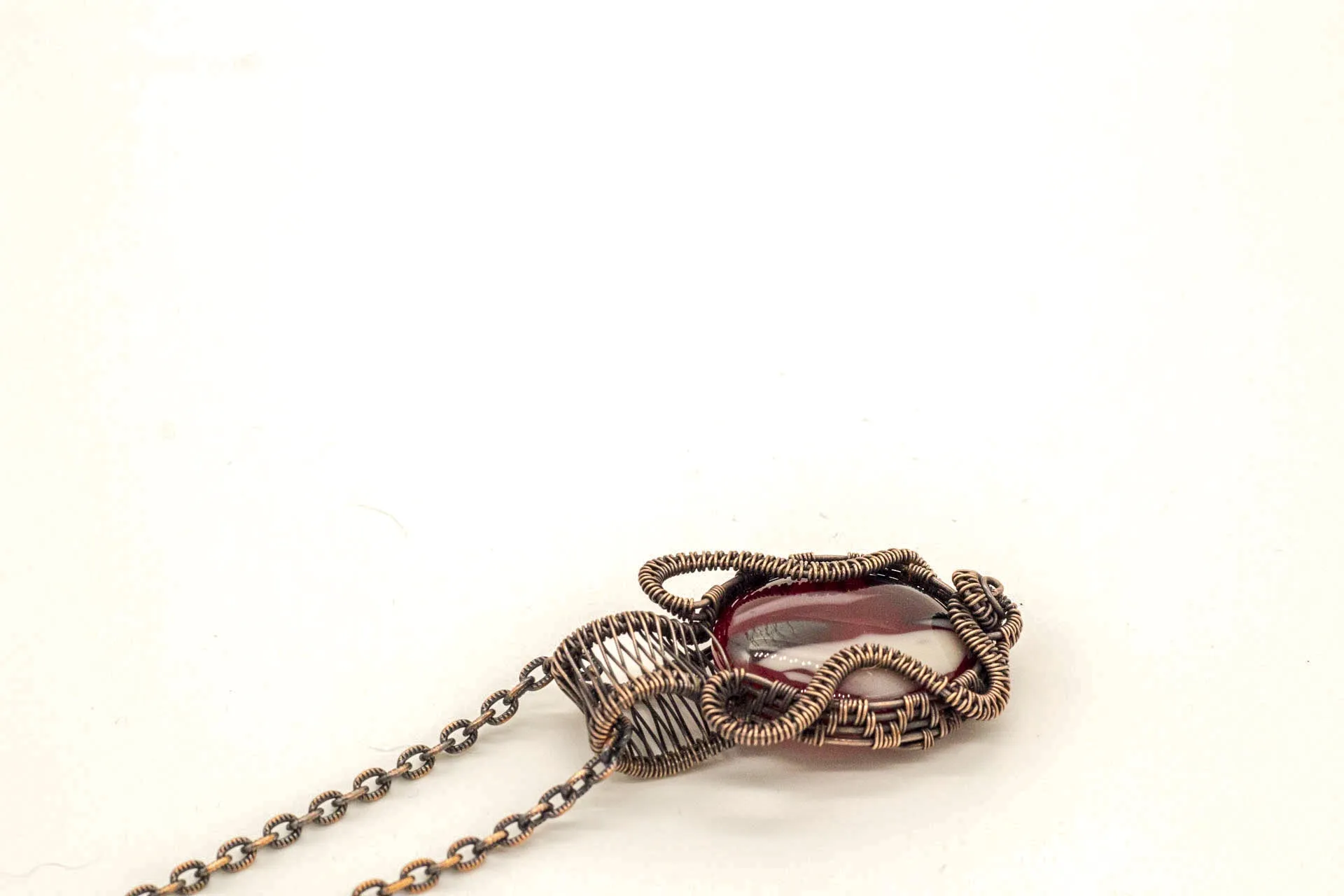 Streaked Red, Black, and White Fused Glass Pendant with Copper Wire Wrapping