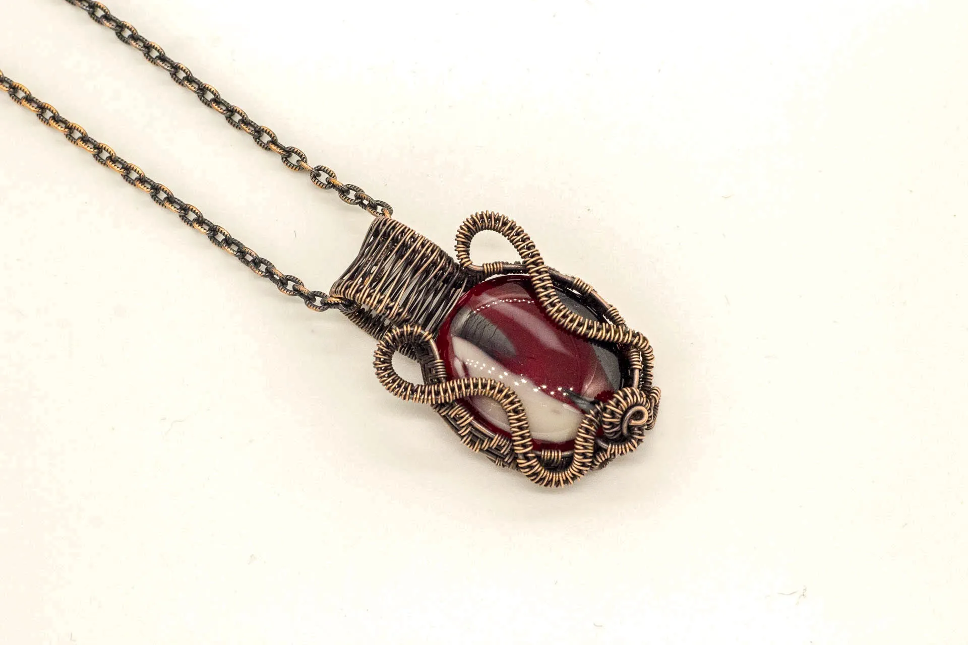 Streaked Red, Black, and White Fused Glass Pendant with Copper Wire Wrapping